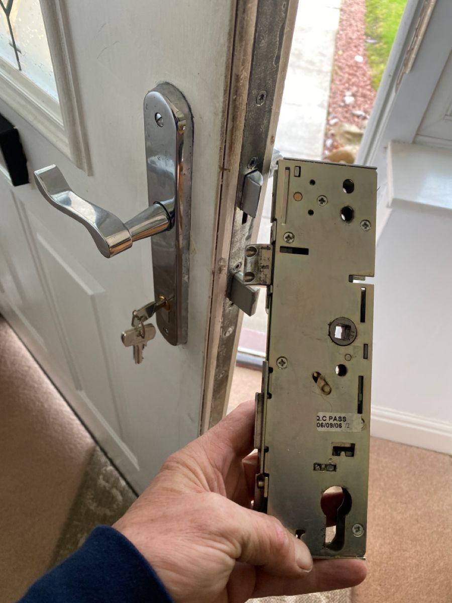 A multipoint gearbox removed from a white composite door