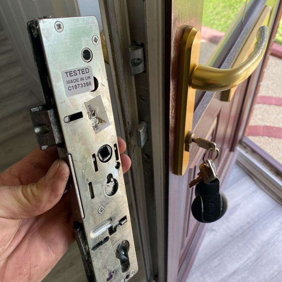 A tested UK-made multipoint mechanism held against a door with a gold handle